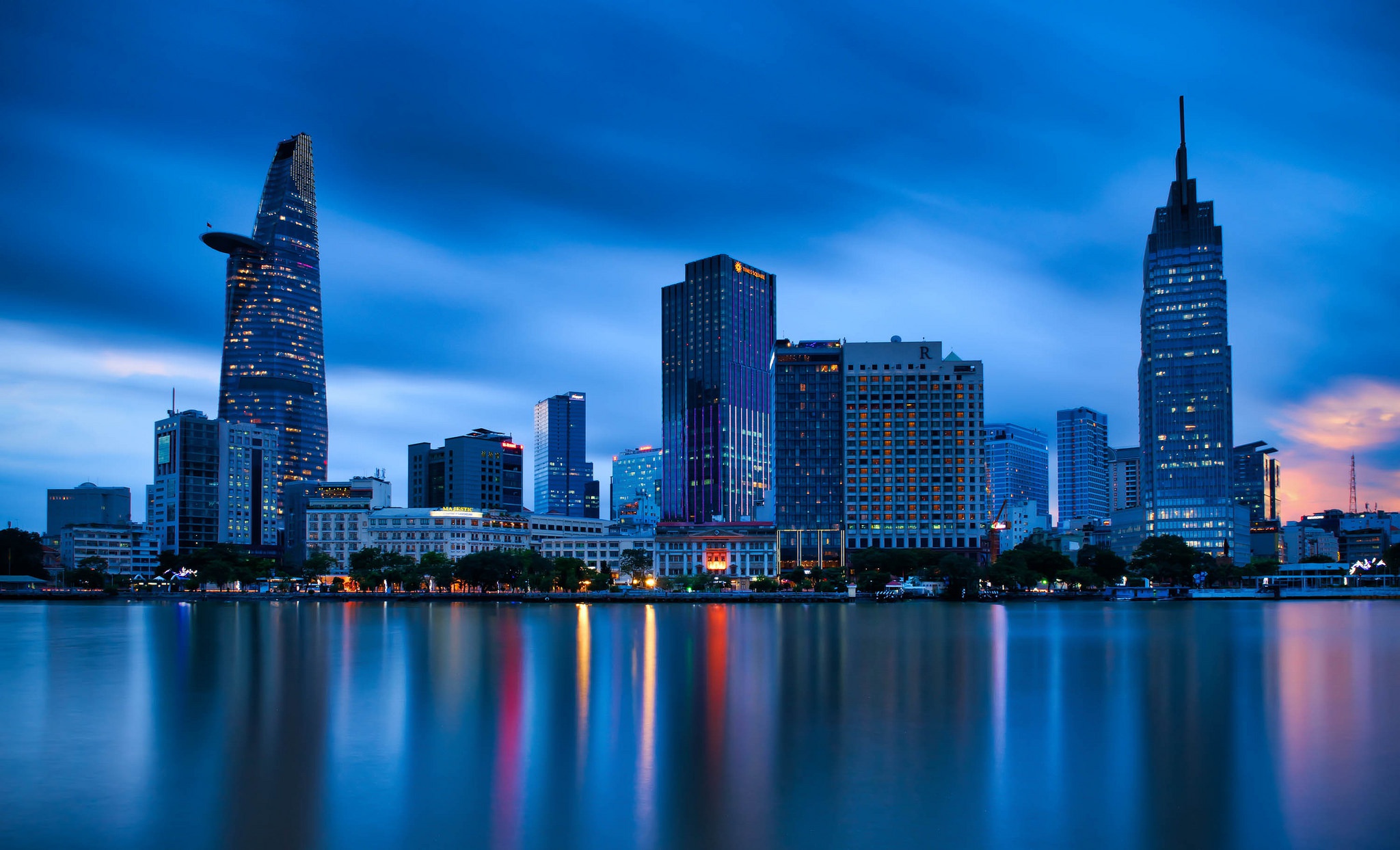 Urban skyline reflected in water at blue hour