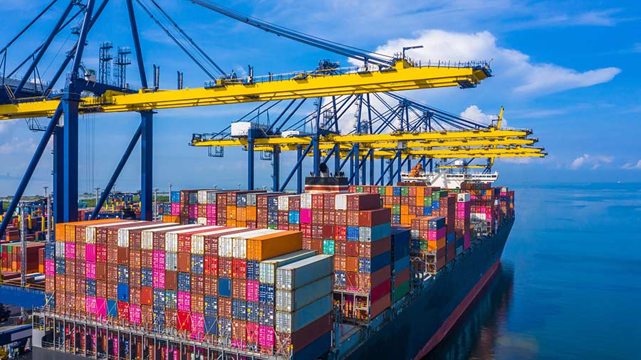 Yellow cargo cranes above stacked containers