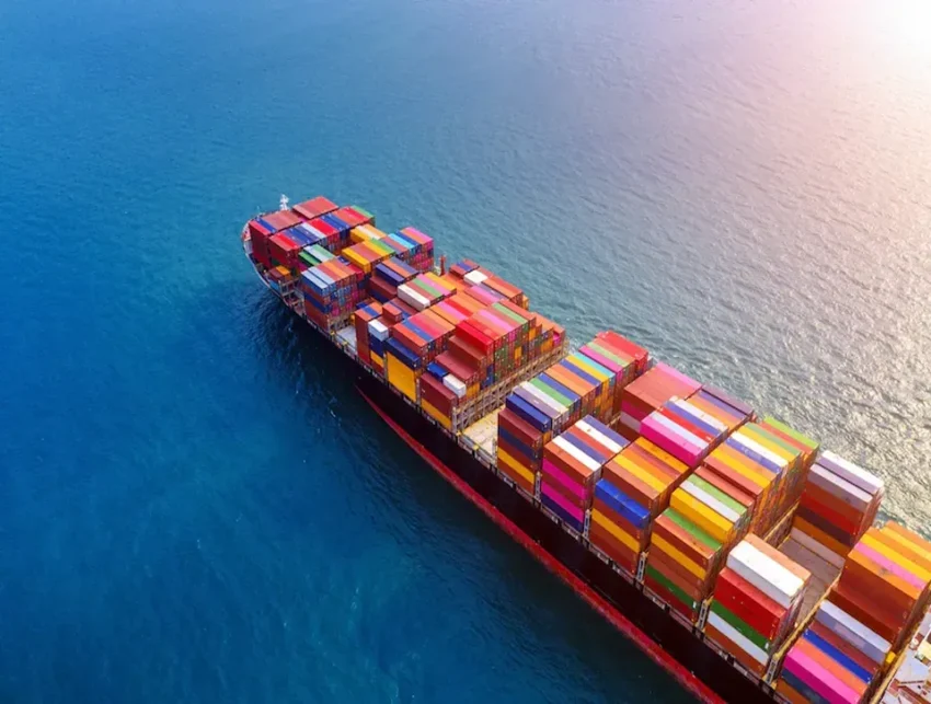 Aerial view of a cargo vessel crossing open water