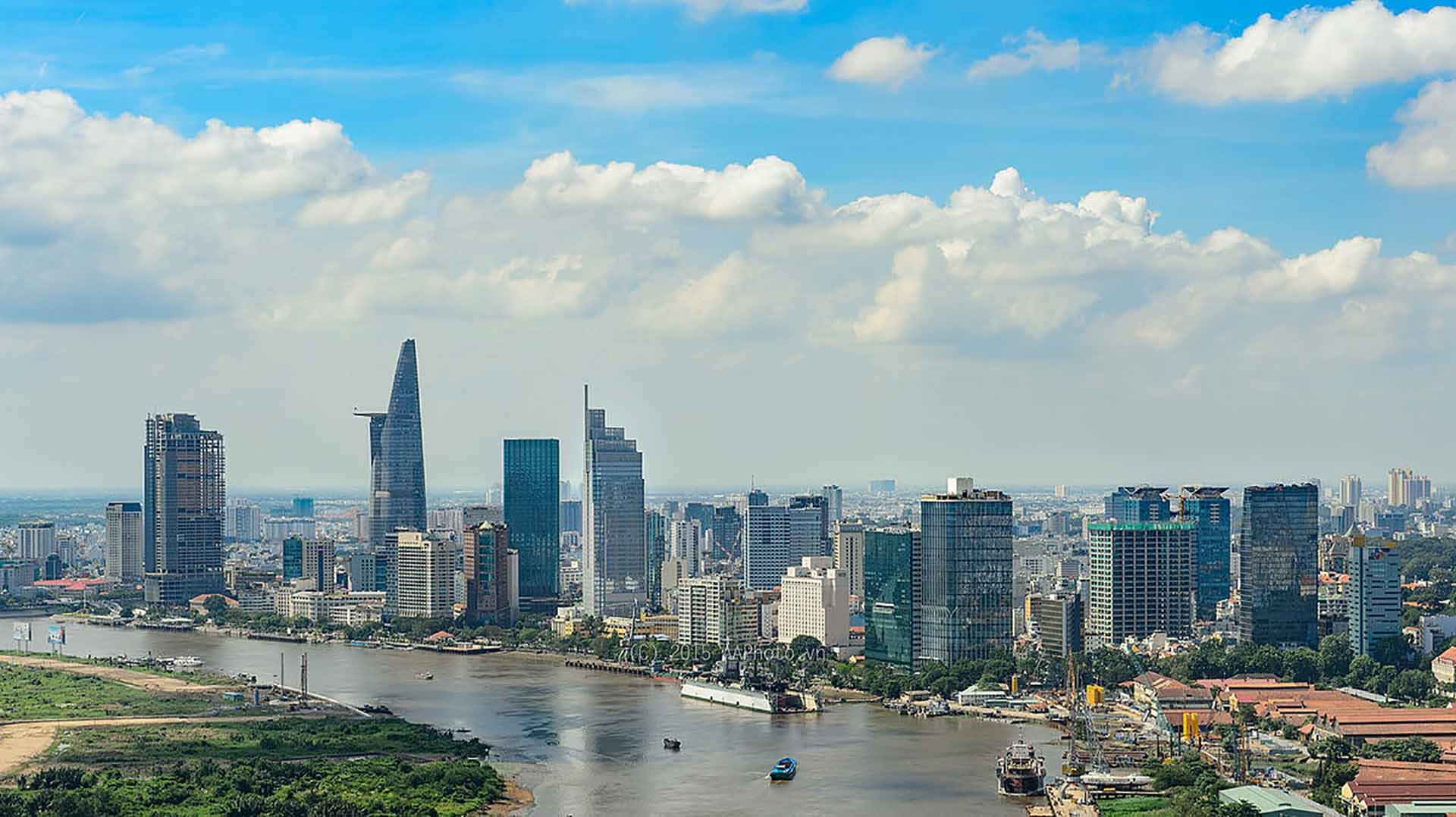 Riverside urban skyline beneath a cloudy sky